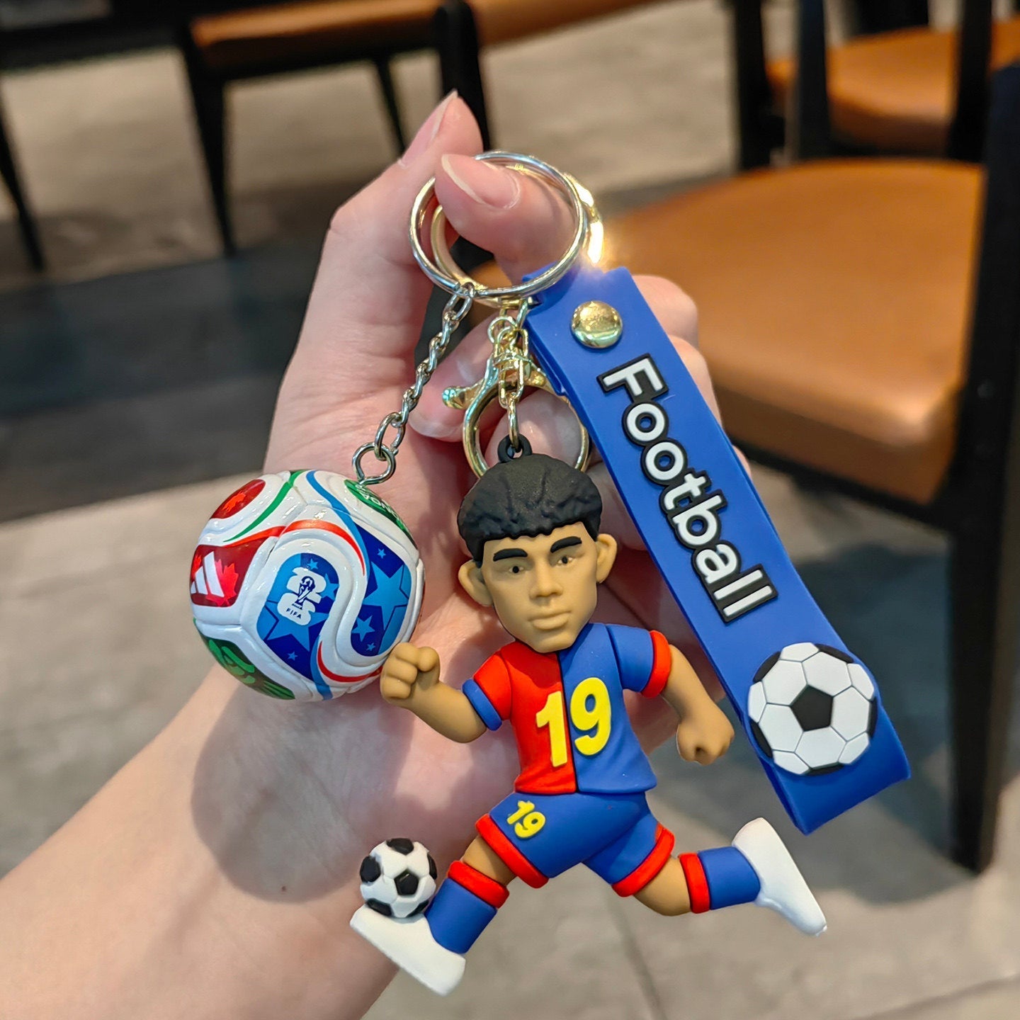 Football keychain with a design featuring professional football players