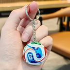 Football keychain with a design featuring professional football players