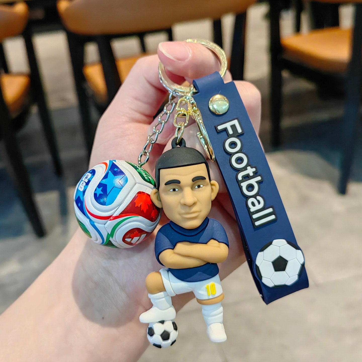 Football keychain with a design featuring professional football players