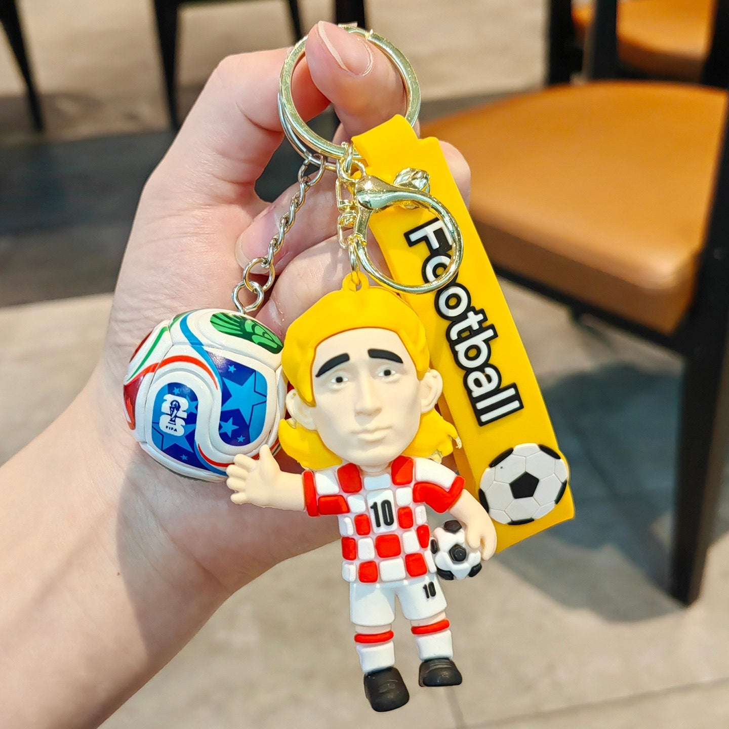 Football keychain with a design featuring professional football players