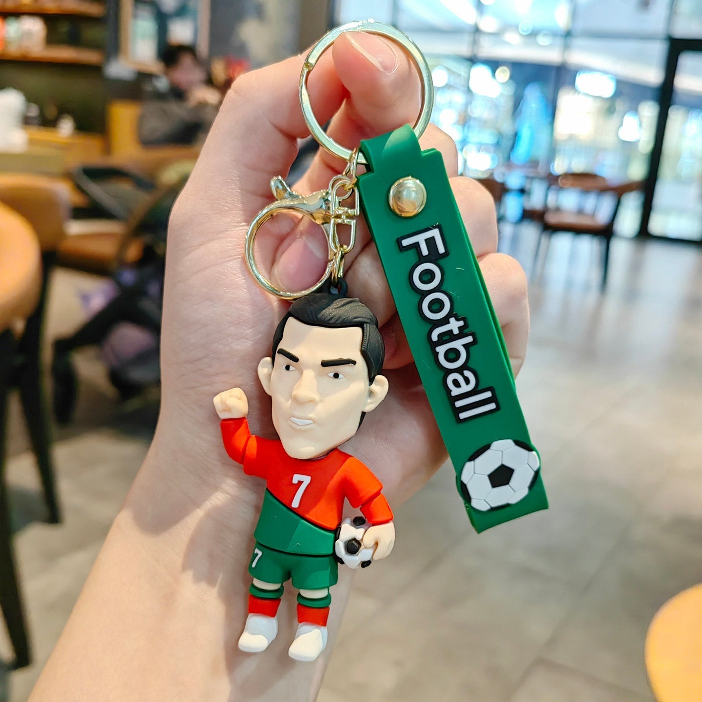 Football keychain with a design featuring professional football players