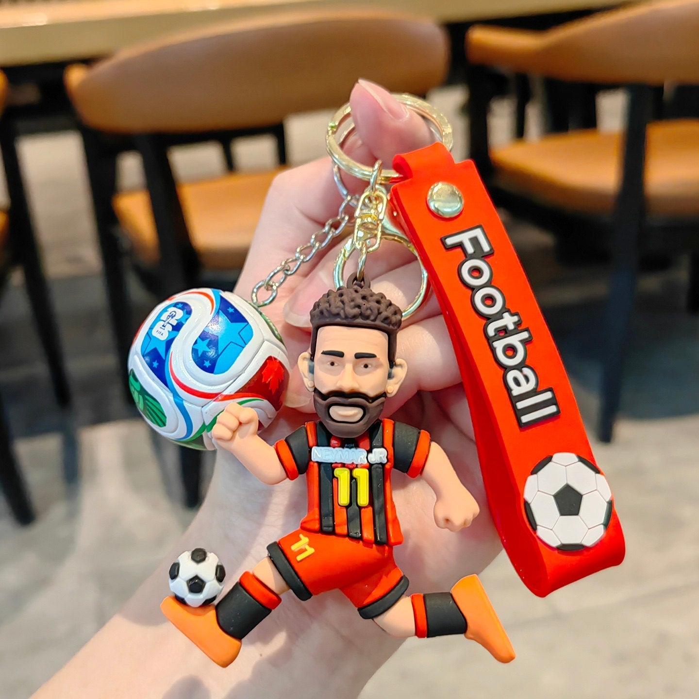Football keychain with a design featuring professional football players