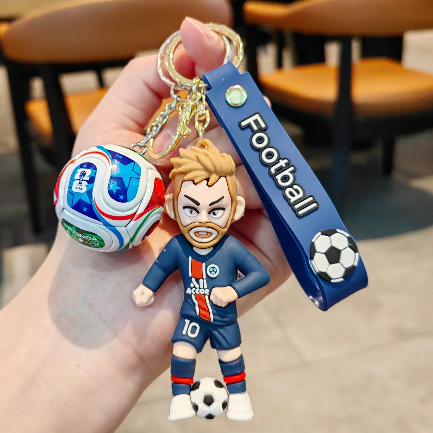 Football keychain with a design featuring professional football players