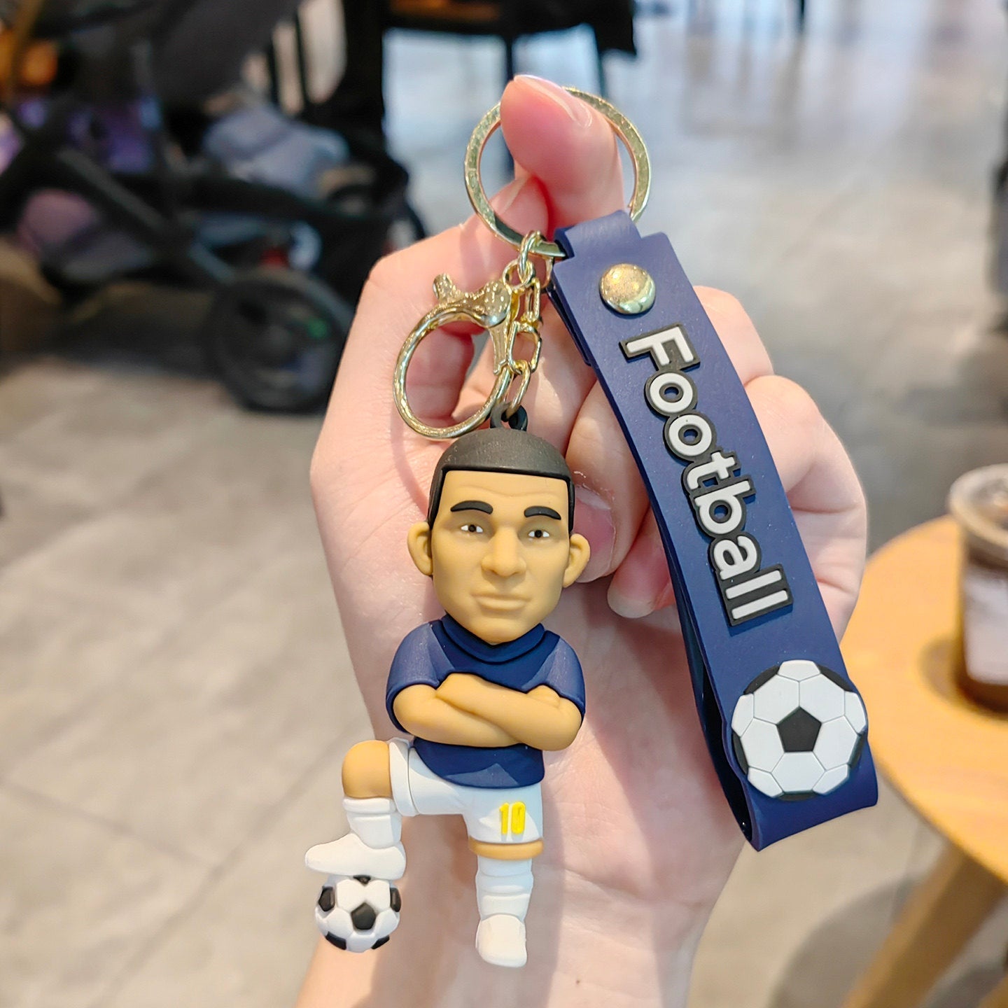 Football keychain with a design featuring professional football players