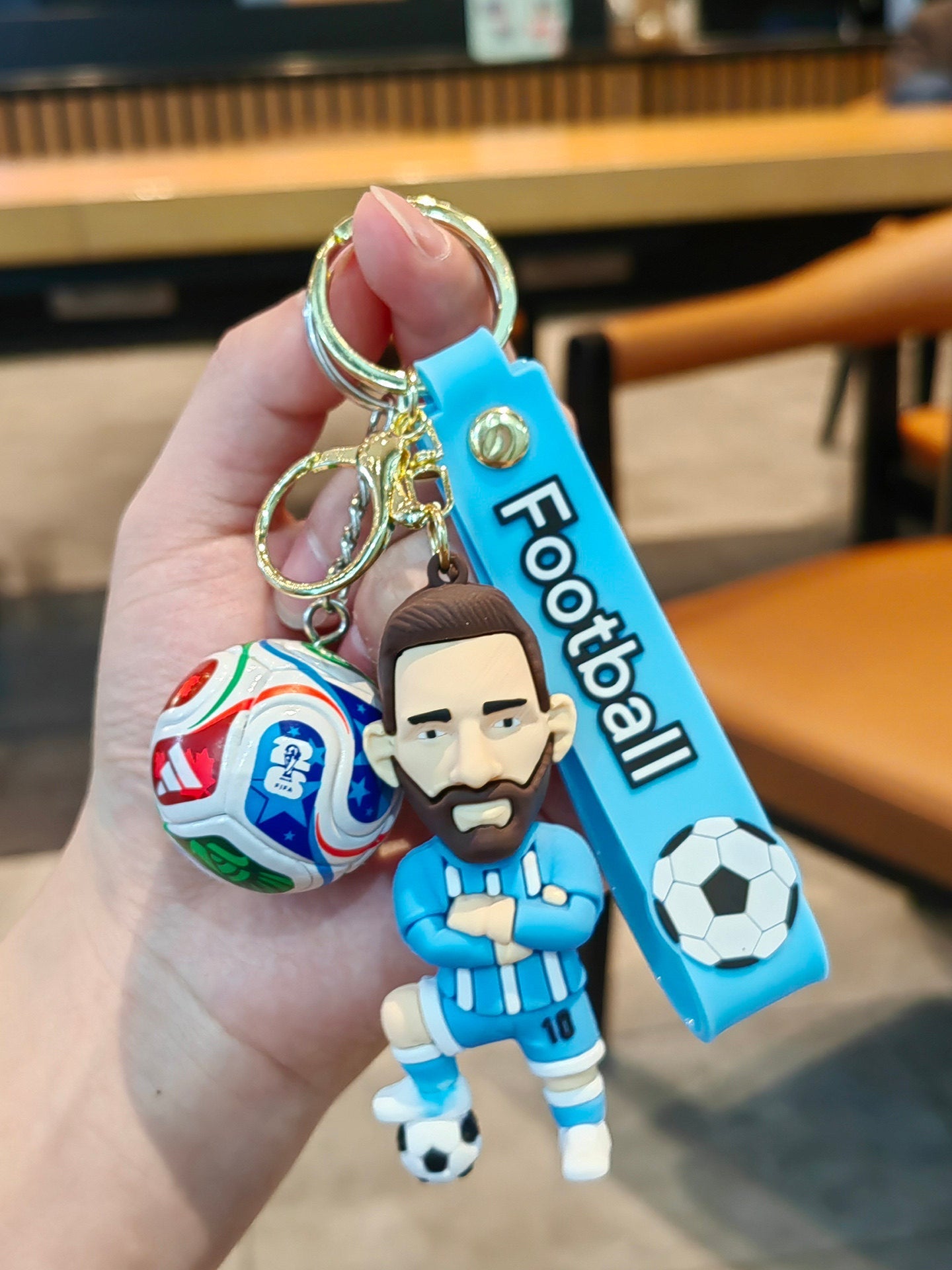 Football keychain with a design featuring professional football players