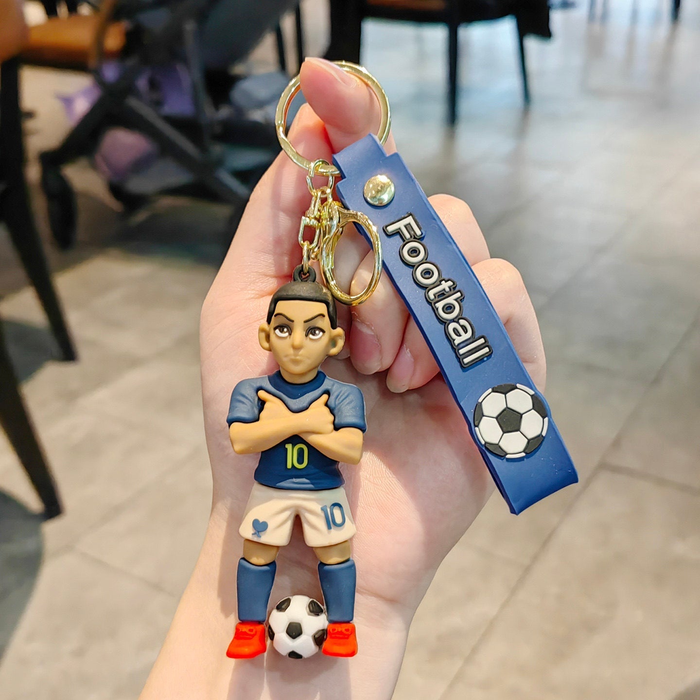 Football keychain with a design featuring professional football players