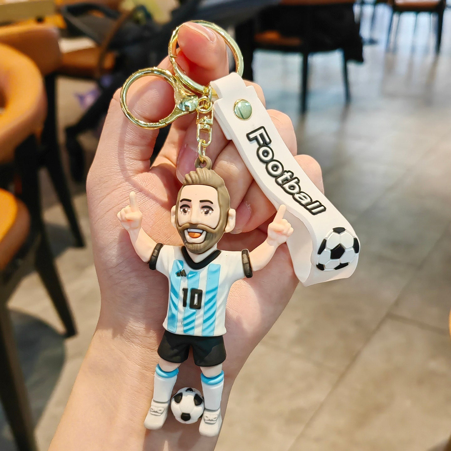 Football keychain with a design featuring professional football players