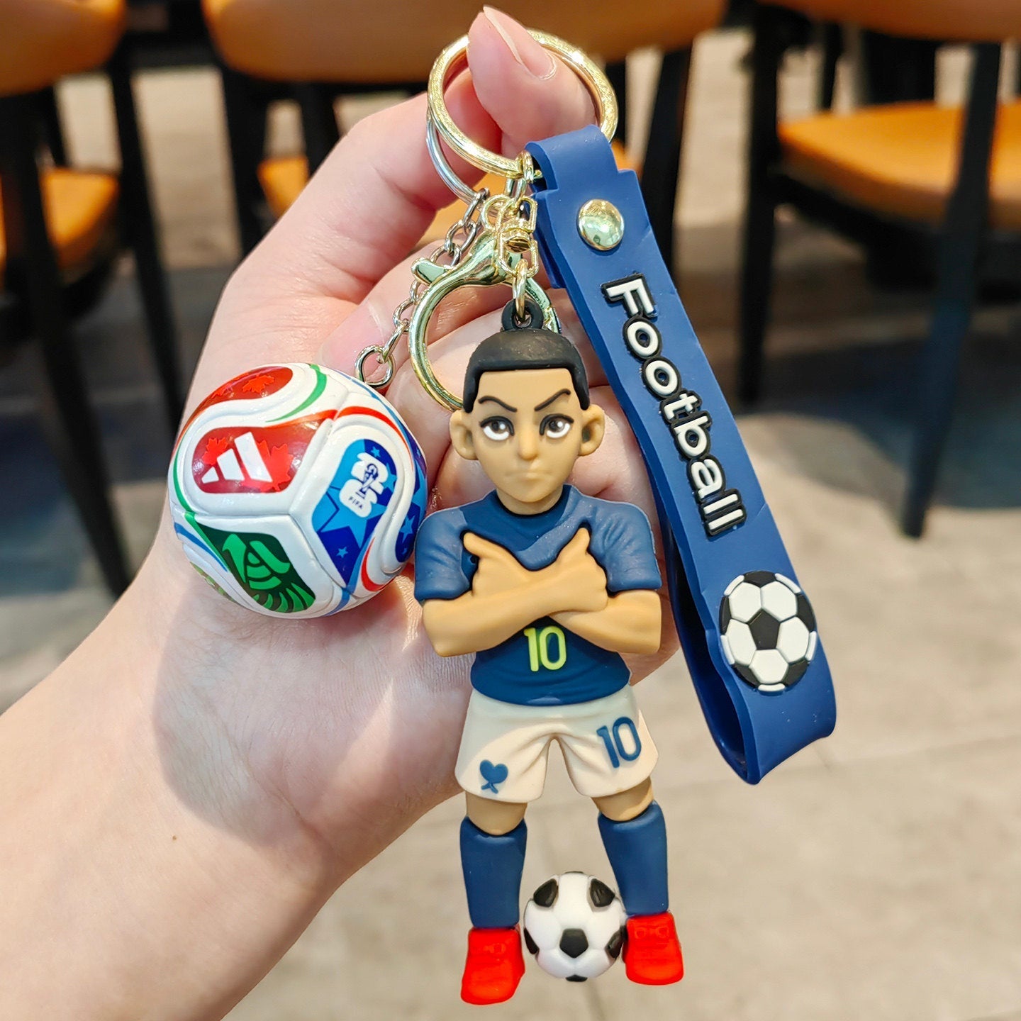 Football keychain with a design featuring professional football players