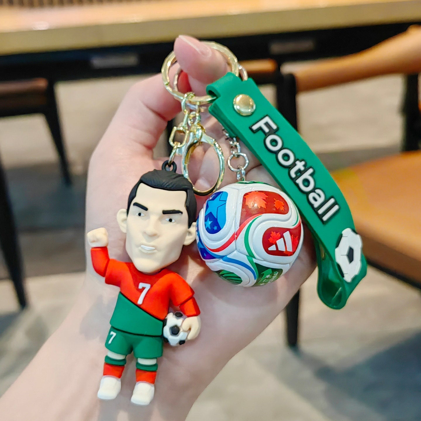 Football keychain with a design featuring professional football players