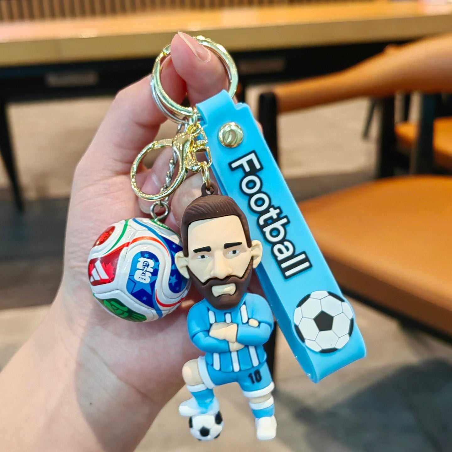 Football keychain with a design featuring professional football players