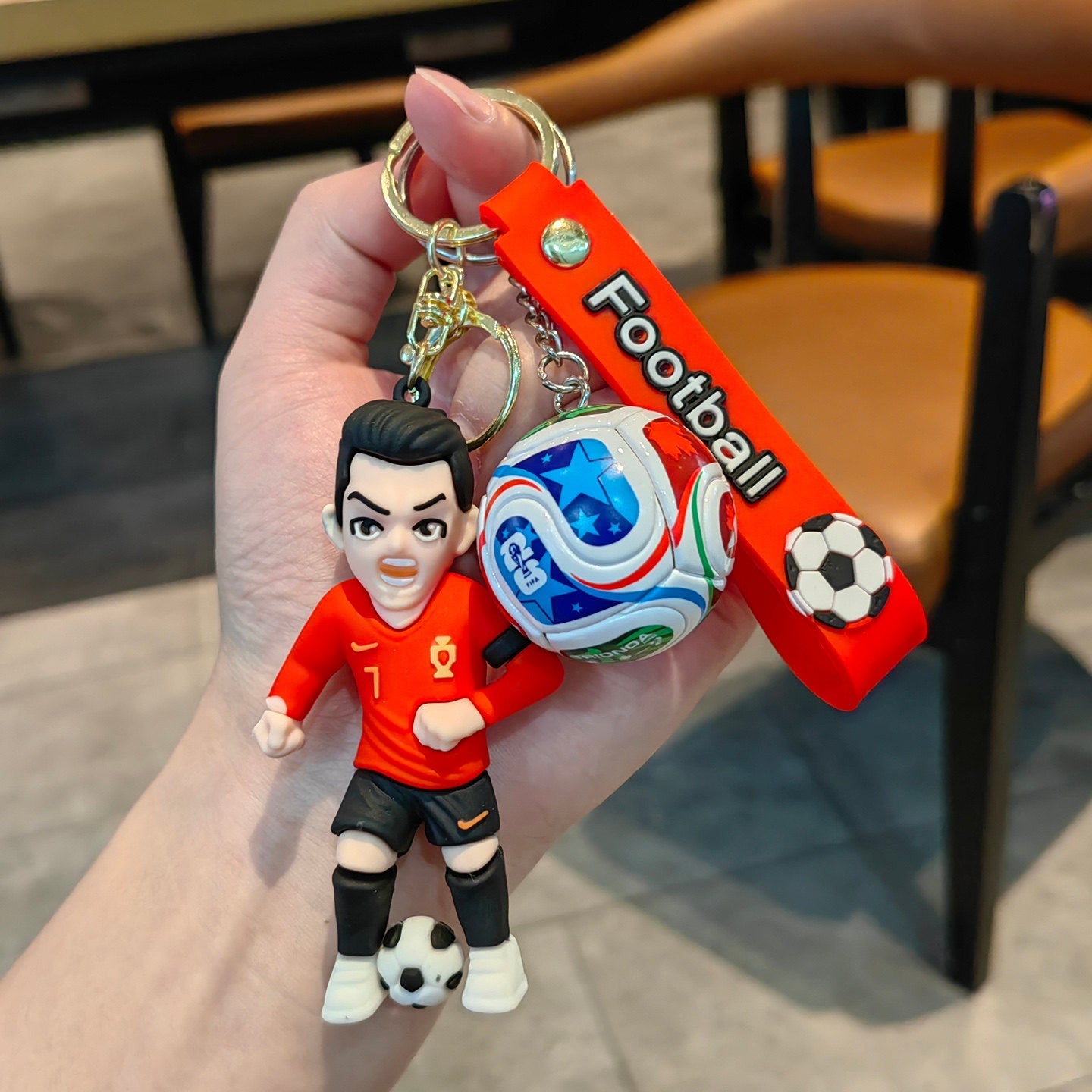 Football keychain with a design featuring professional football players