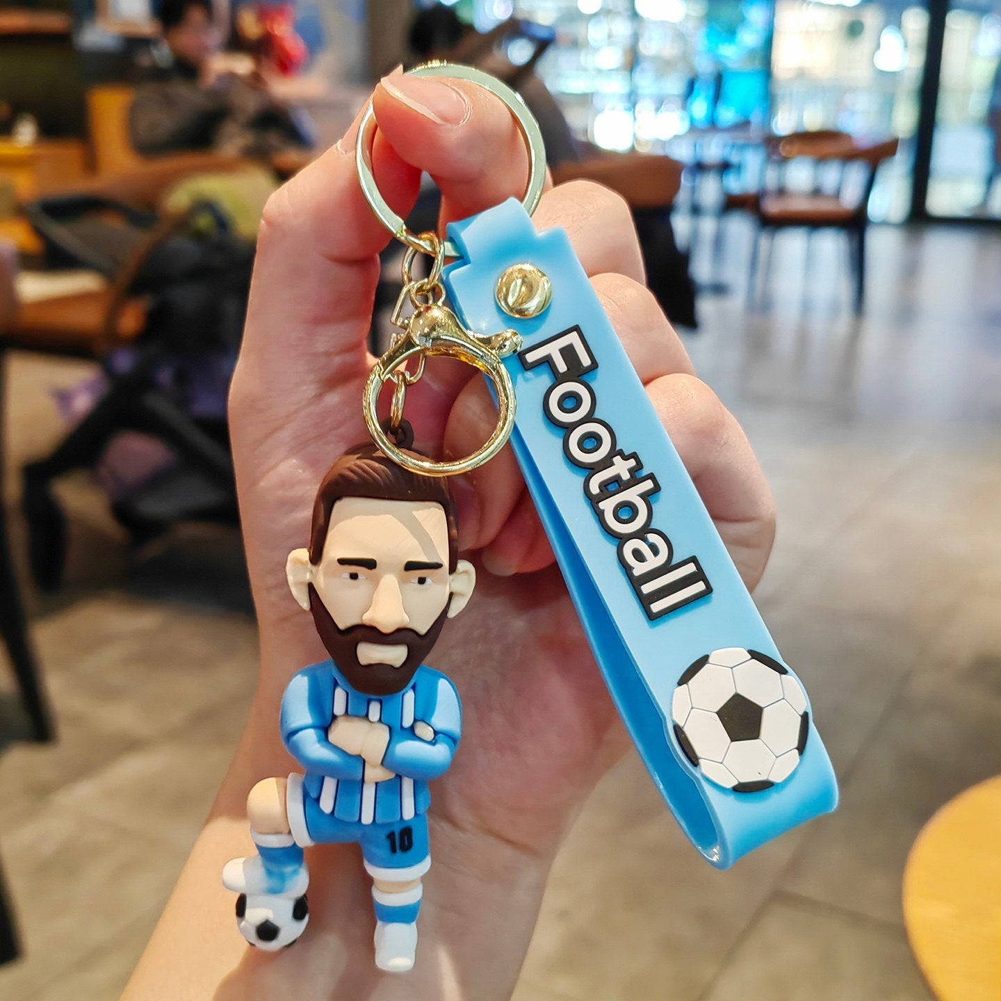 Football keychain with a design featuring professional football players