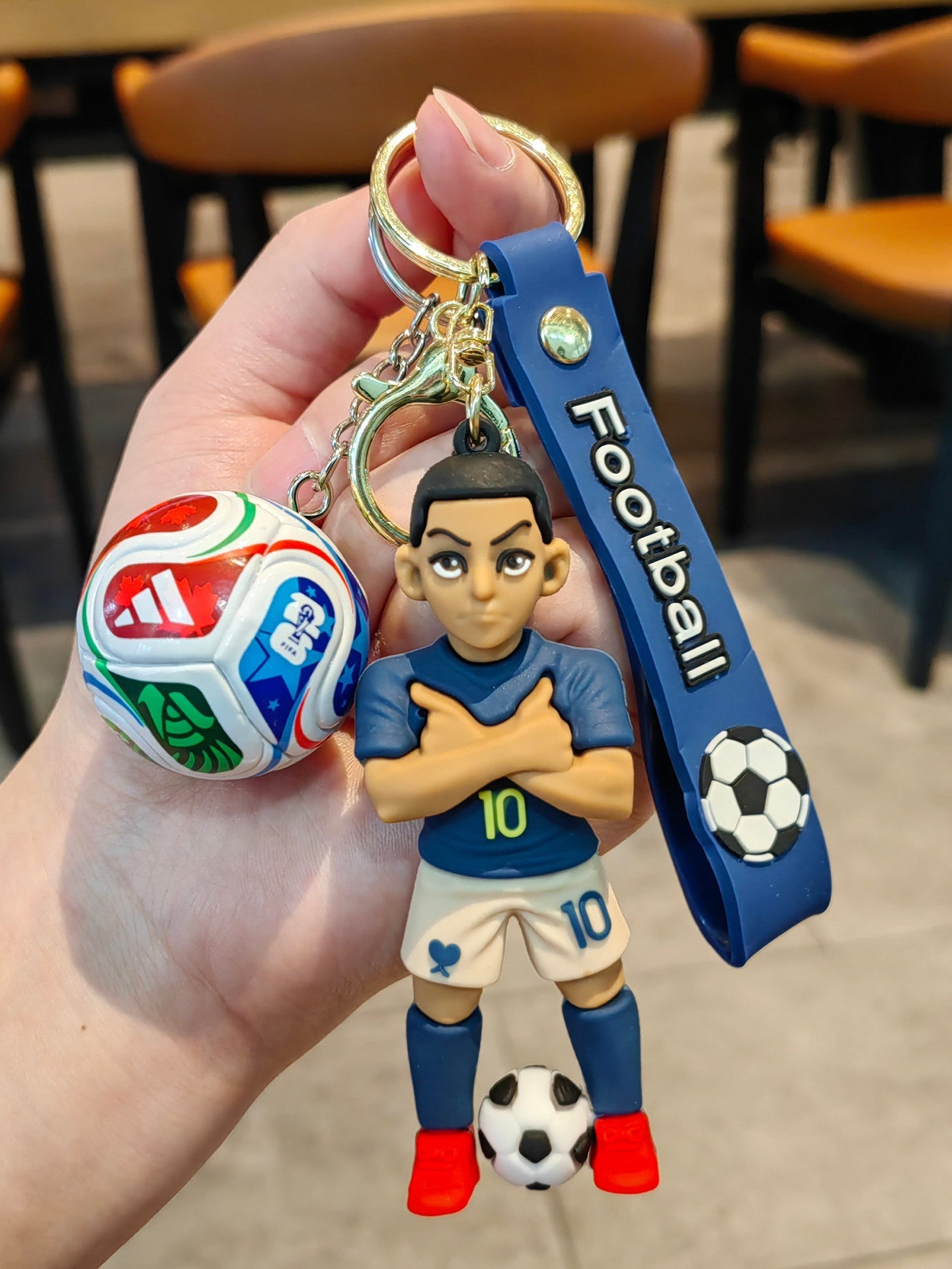 Football keychain with a design featuring professional football players
