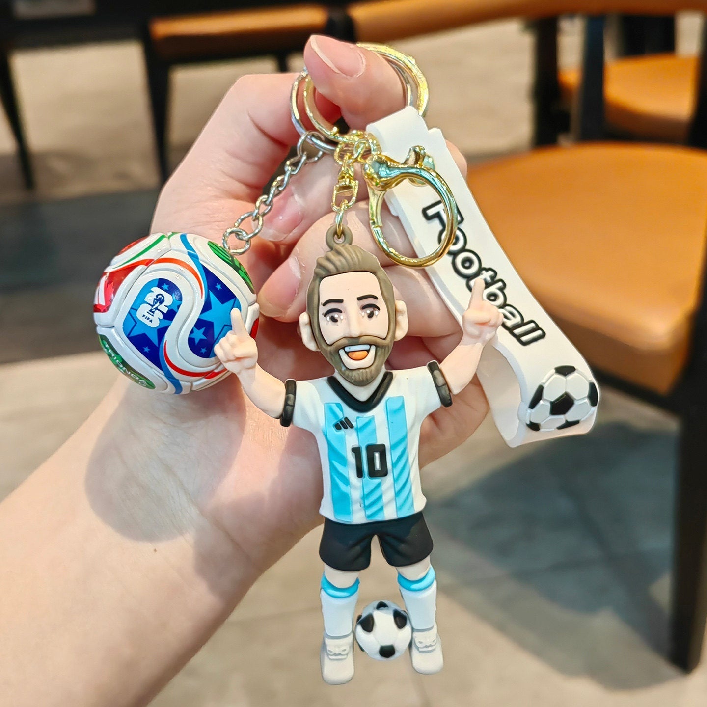 Football keychain with a design featuring professional football players
